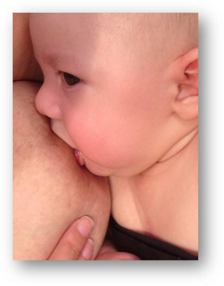 Image showing proper attachment and latch of a baby to the mother's nipple.