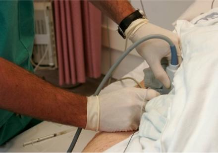 Health care provider administers a regional analgesic technique.