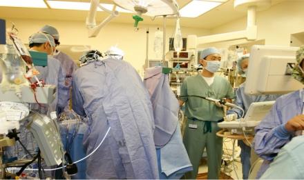 Health care staff seen during a surgery in an operating room.